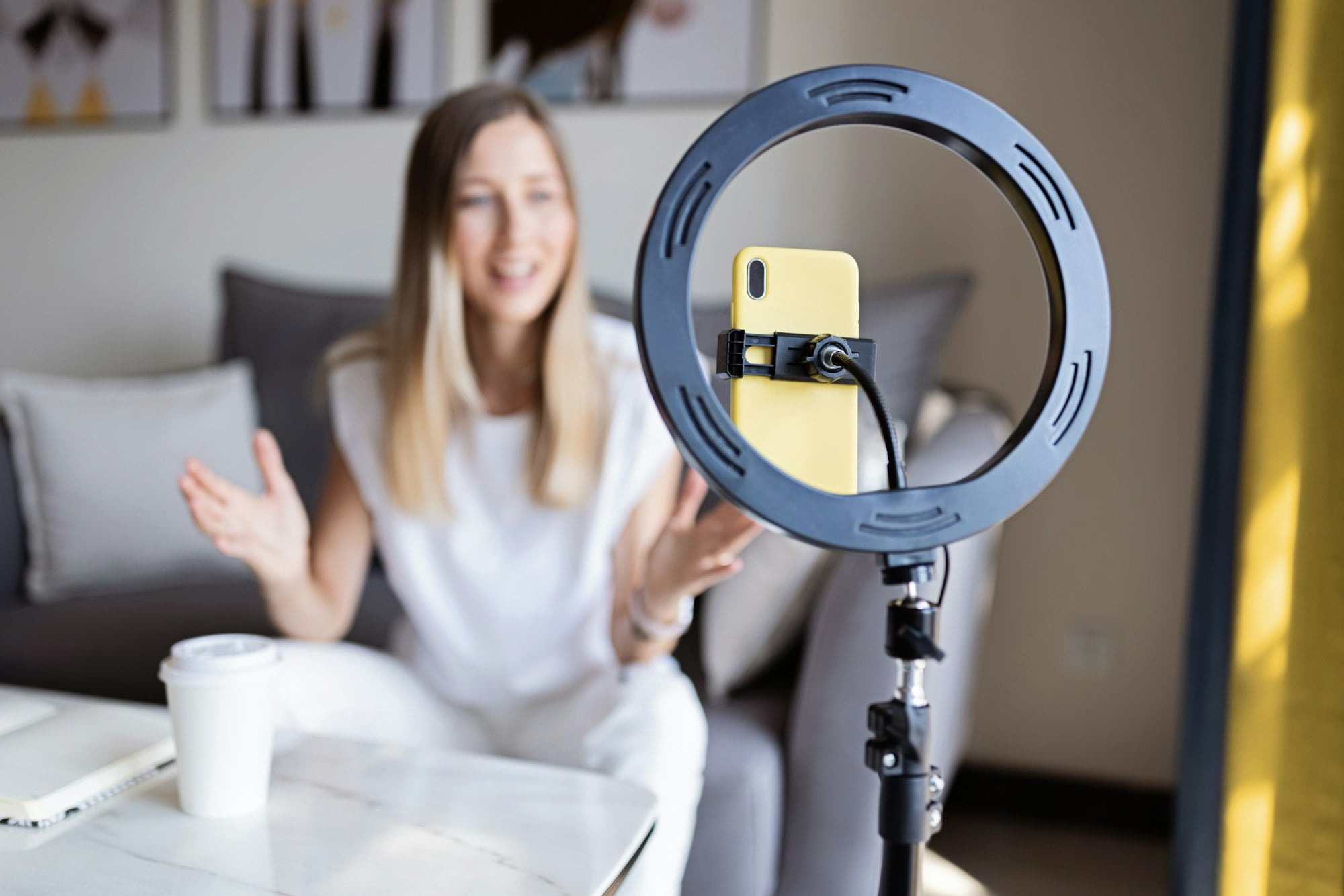 Happy caucasian woman using technology at home. Lifestyle Blogger communicating with followers